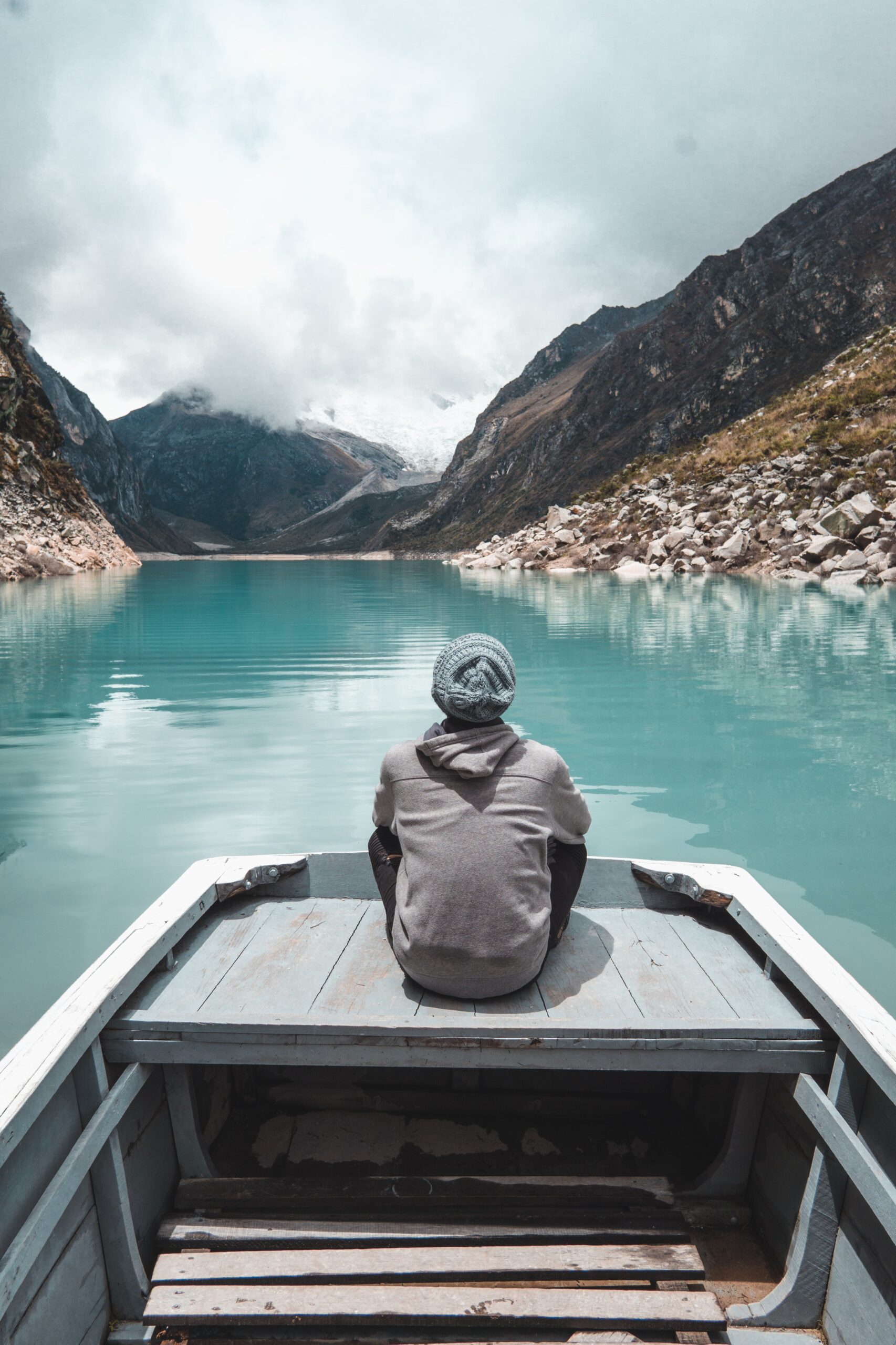 Your Future person sitting on a boat looking out over a still lake and beautiful scenery